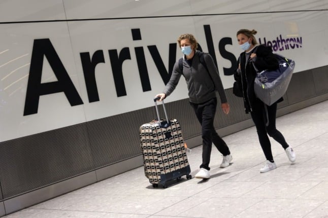 Pictured are travellers arriving at London Heathrow Airport. 