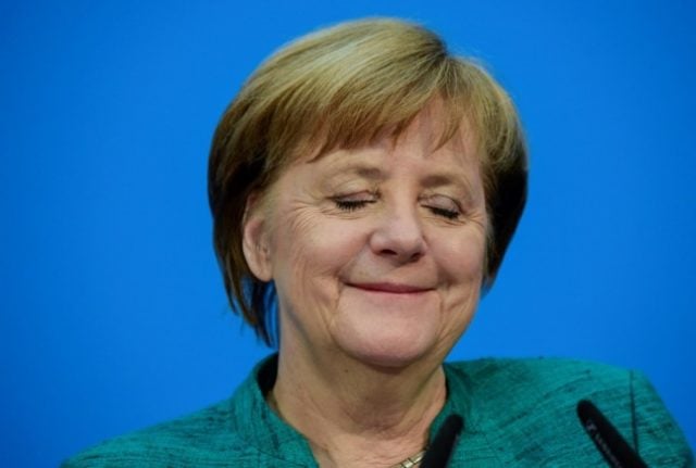 Outgoing German Chancellor Angela Merkel briefly closes her eyes and smiles at a 2018 press conference in Berlin.