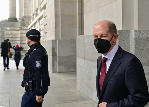 German Chancellor Olaf Scholz (R) leaves the Bundestag in Berlin.