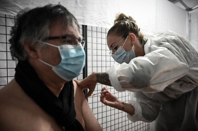 A patient receives a dose of Moderna vaccine in a French hospital. Booster doses will soon become a requirement for people who wish to use the health pass. 