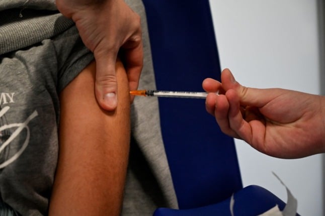 Vaccination is administered to the arm of a child.