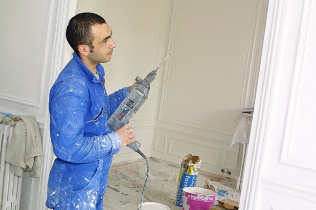 A French worker renovates a Parisian property. Planning permission applications will become easier from January 1st.
