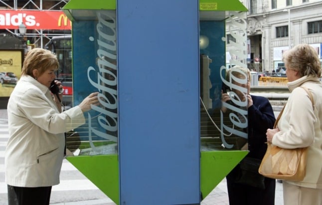 A woman uses a Telefonica public phone in Madrid, 15 February 2007.