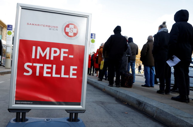 People wait in front of a vaccination bus during the coronavirus disease (COVID-19) outbreak, as Austria's government has imposed a lockdown on people who are not fully vaccinated, in Vienna, Austria, November 18, 2021. REUTERS/Leonhard Foeger