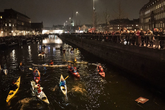 People canoe in Copenhagen's canals during a Christmas 