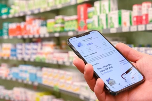A person holds the e-Rezept app in a pharmacy in Oldenburg, Lower Saxony.