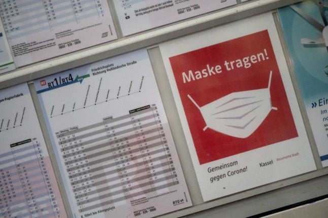 A sign telling travellers to wear a mask at a train station in Kassel, Hesse.
