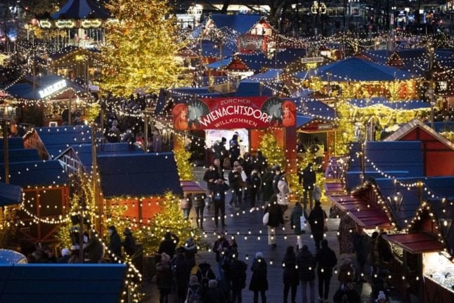People visit the Wienachtsdorf Christmas market at Zurich's Sechseläutenplatz.