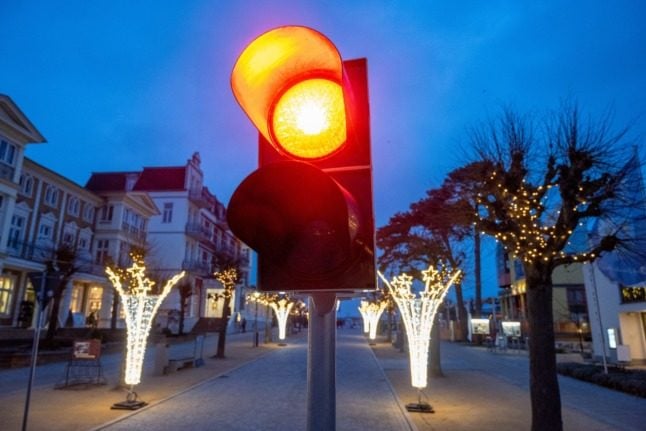 A red traffic light shines on the beach promenade in the Baltic Sea resort on the island of Usedom