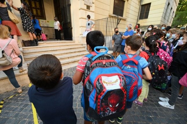 Children wait to enter a school in Italy in accordance with anti-Covid rules.