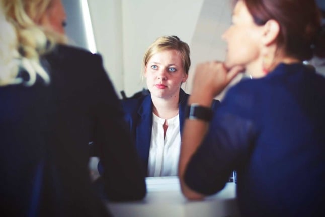 A woman makes eye contact at a job interview