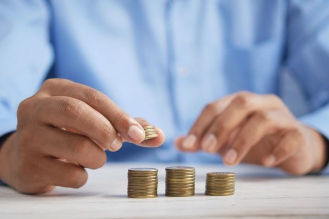 A man counts his money. Important tax deadlines are coming up in France. 