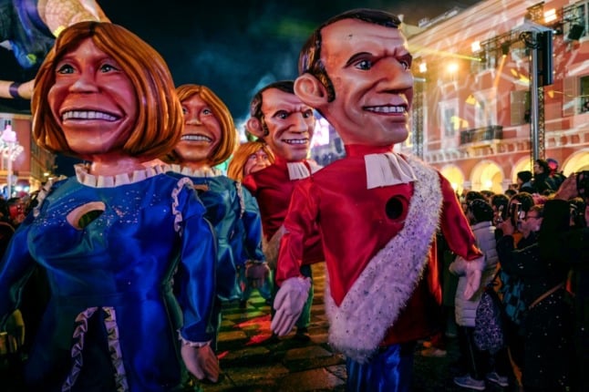 Figurines depicting French President Emmanuel Macron and his wife Brigitte Macron parade during the Nice Carnival. 