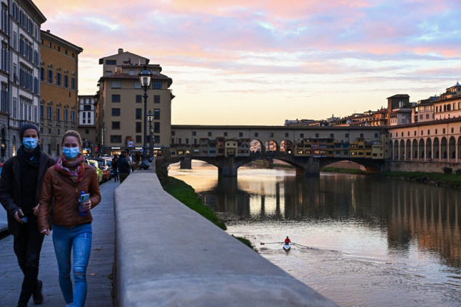 People walk in central Florence.