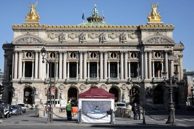 A health worker sits in a Covid test tent near the Paris opera.