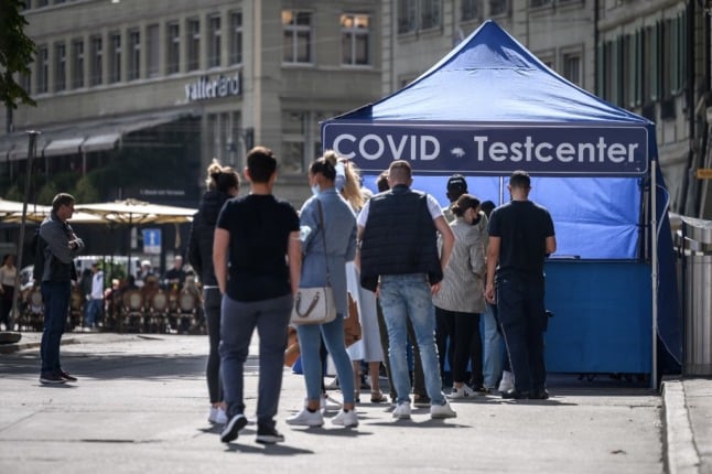 People queue at a Covid test center installed in a street of Swiss capital Bern on September 17, 2021.