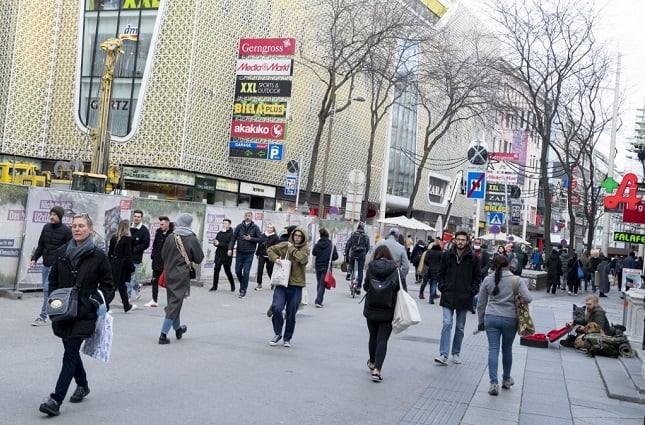 Crowds walk down the famous shopping street Mariahilferstrasse, in Vienna, Austria