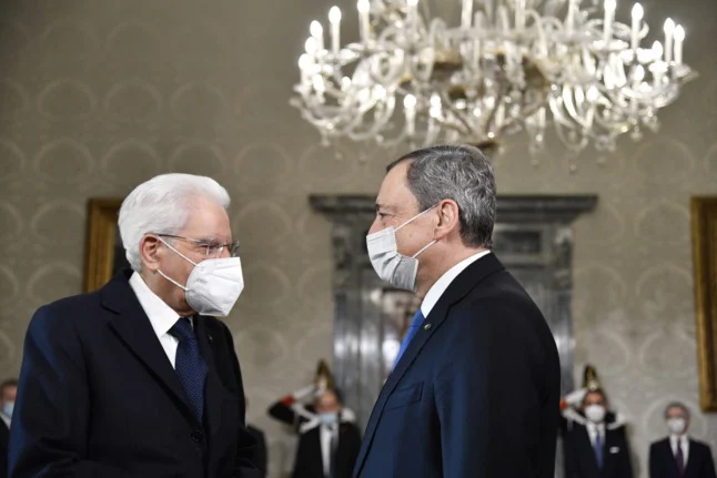 Italy's current President Sergio Mattarella greets Prime Minister Mario Draghi at the Quirinal presidential palace in Rome on November 26, 2021. Alberto PIZZOLI / POOL / AFP