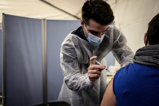 A patient receives a dose of the Pfizer-BioNTech (Comirnaty) Covid-19 vaccine.