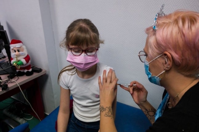 A child receives a Covid vaccine in France. From now one, children aged 5-11 need permission from both parents to get vaccinated.
