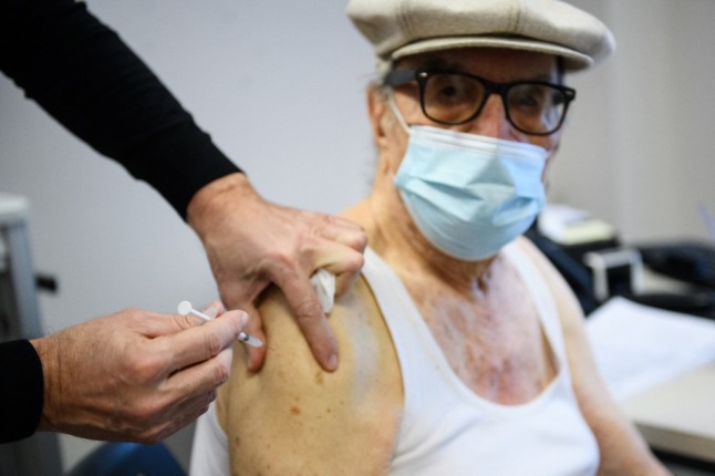 A man receives a booster dose in France. 