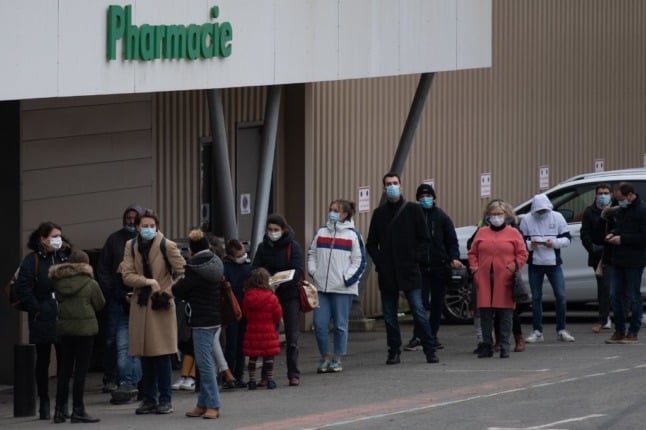 People queue outside a pharmacy in western France. 