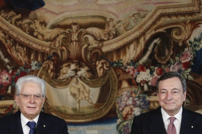 Italian President Sergio Mattarella (L) and Prime Minister Mario Draghi at the Quirinale Presidential Palace in Rome