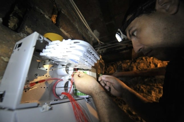 A technician connects fibre optic cables to a building in France. 