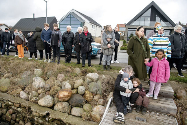 People in Kolding look on as a tug boat removes a dead North Sea beaked whale from the town's harbour on January 26th.