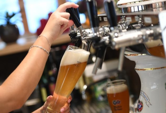 A person pouring a beer. 