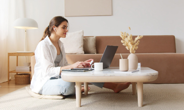 A woman works on her laptop at home