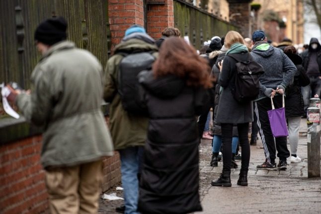 People queue for a PCR test in Berlin's Kreuzberg area on Sunday. 