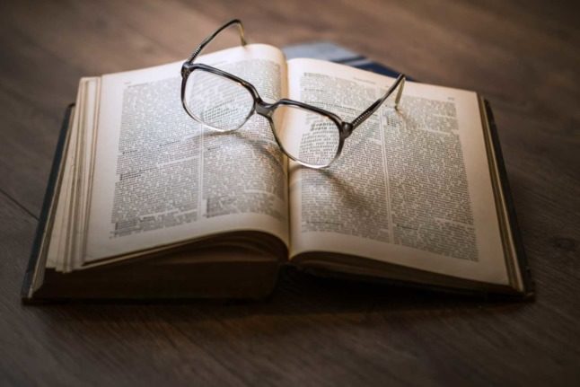 A set of glasses seen laying on a lawbook