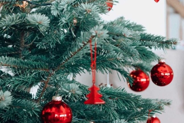 A Christmas tree with decorations seen close up. Photo by Felicia Buitenwerf on Unsplash