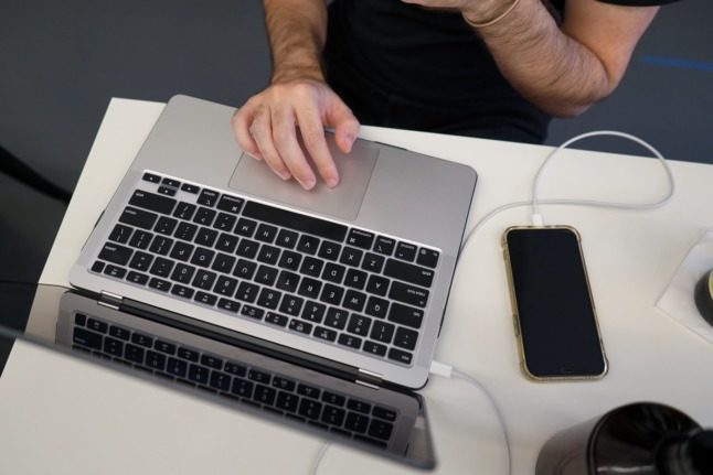 Pictured is somebody hard at work on their laptop. 