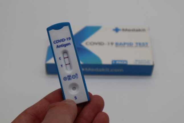 A positive Covid antigen test seen up close. Photo by Medakit Ltd on Unsplash