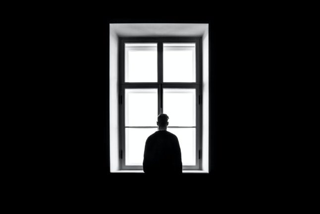 Man standing in front of a window