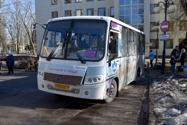 A bus evacuates passengers from Donetsk on February 19, 2022.