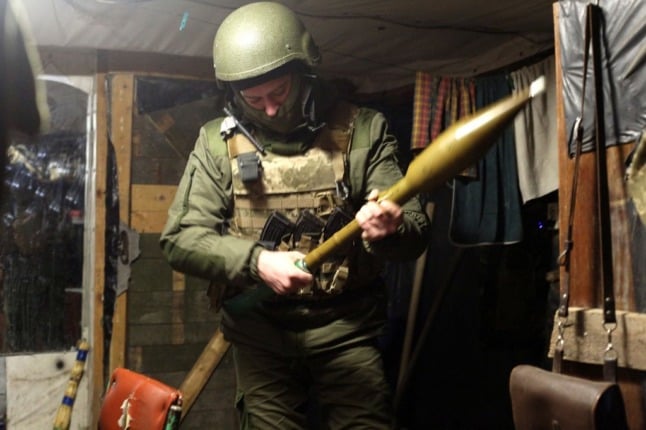 A Ukrainian soldier holds a rocket-propelled grenade launcher