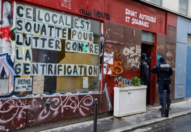 French police prepare to breach a property occupied by squatters.
