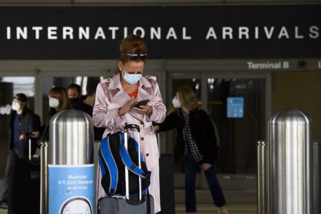 Travellers wait at Rome's Fiumicino airport.