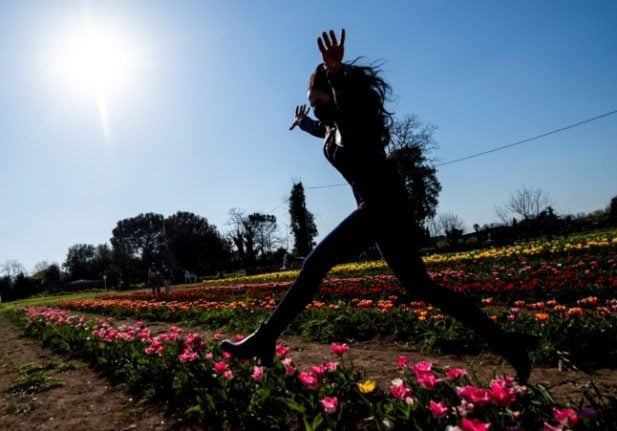 A woman jumps in the TuliPark on the outskirts of Rome on March 31, 2021.