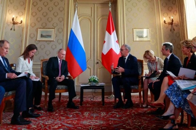 Russian leader Vladimir Putin and former President Guy Parmelin. DENIS BALIBOUSE / POOL / AFP