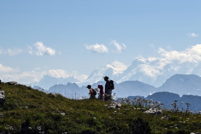Hikers walk in the French Alps
