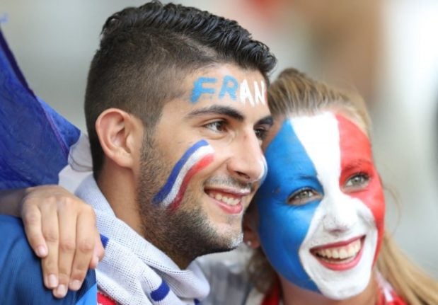 French football supporters smile during a match