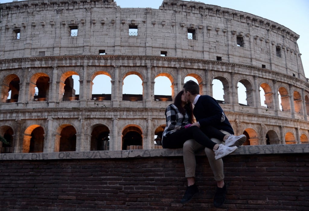 A couple kisses in front of the Colosseum in Rome on Valentine's Day on February 14, 2017.