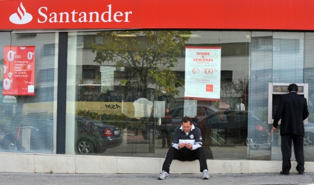 A man withdraws cash from a Santander branch in Madrid.