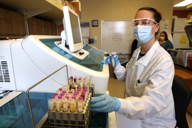 A scientist conducts tests on a batch of Novavax vaccines. France will receive its first shipment of these vaccines during the week.