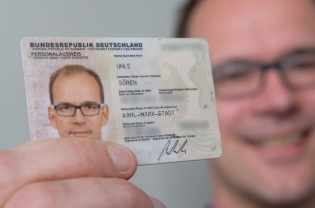 A man presents his German ID card