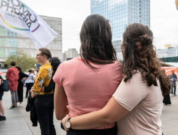 Two women stand together in Alexanderplatz, Berlin, on the International Day for Lesbian Visibility in 2019.
